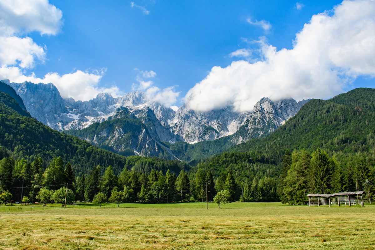 A beautiful mountainous landscape with greenery under a cloudy sky