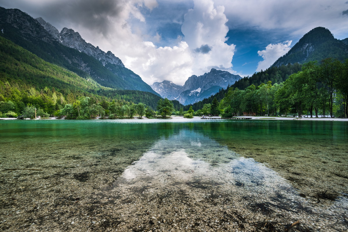 Clear water and Julian Alps reflection in Lake Jasna, Slovenia.